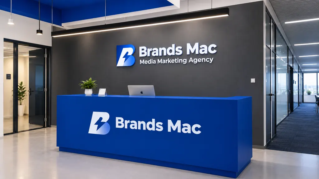 A reception desk and wall carrying Brands Mac signage.