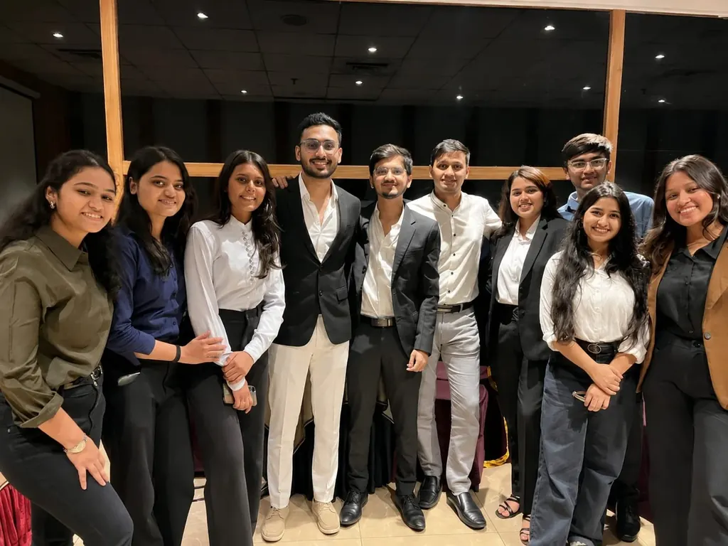 A group of people standing together and smiling.